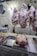 There are several cuts of raw meat hanging on hooks in a butcher shop, with a pig's head displayed in a metal tray on the counter. A person sits in the background partially visible behind a scale.