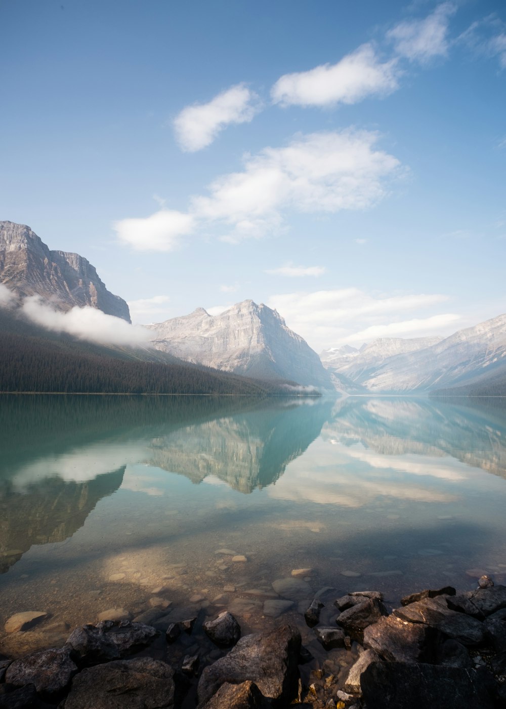 a body of water with mountains in the background