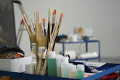 a group of pens and pencils on a desk