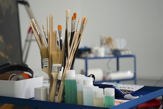 a group of pens and pencils on a desk