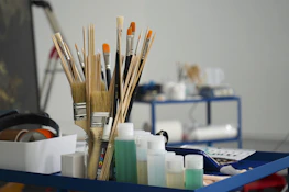 a group of pens and pencils on a desk