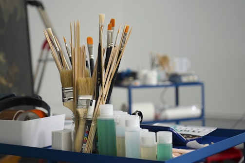 a group of pens and pencils on a desk
