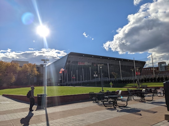 A bright, modern government building with clear signage and people gathering outside on a sunny day.
