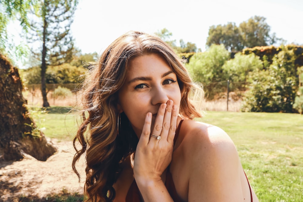 a woman with her hand on her face