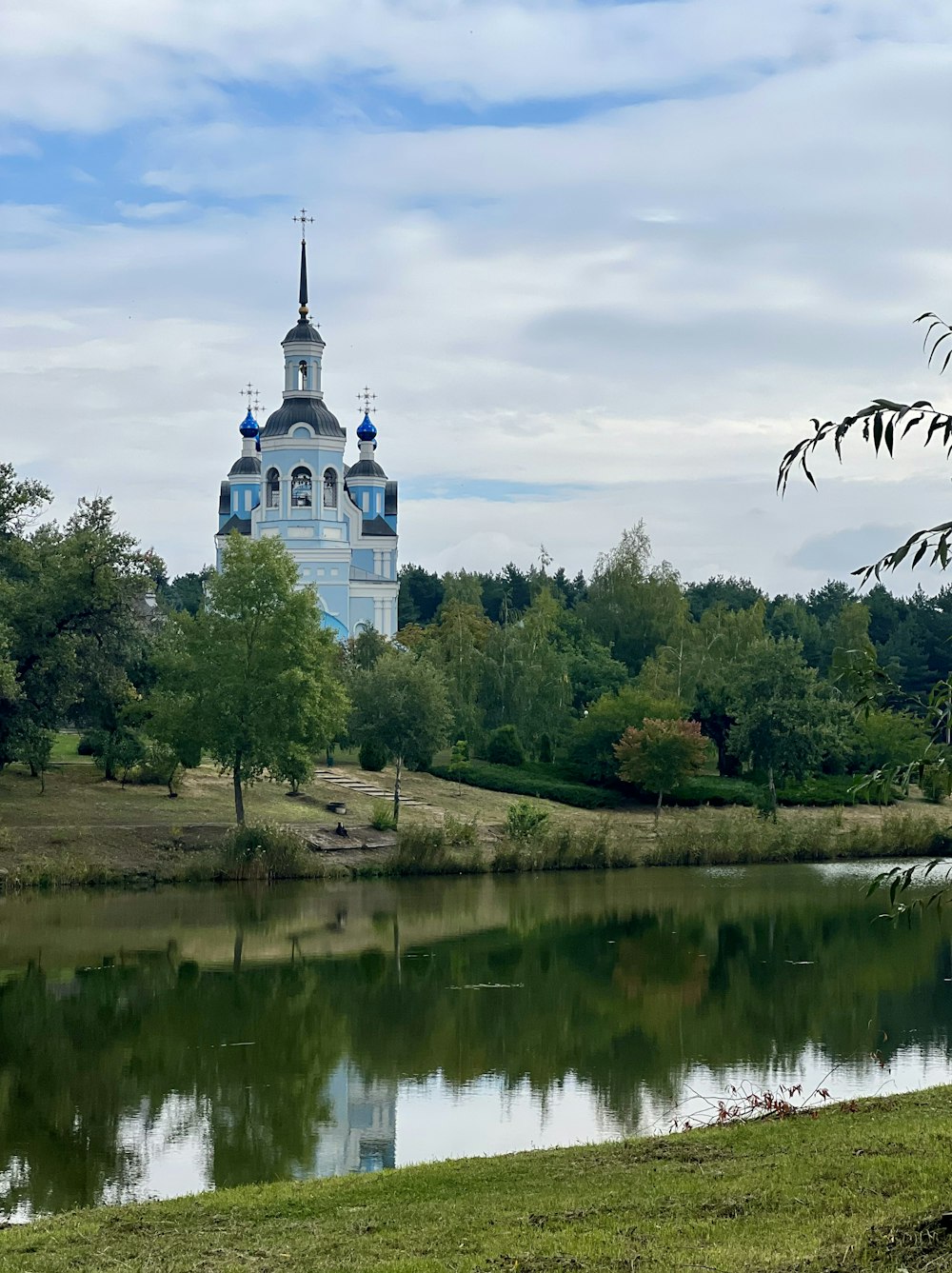 a building with a tower by a body of water