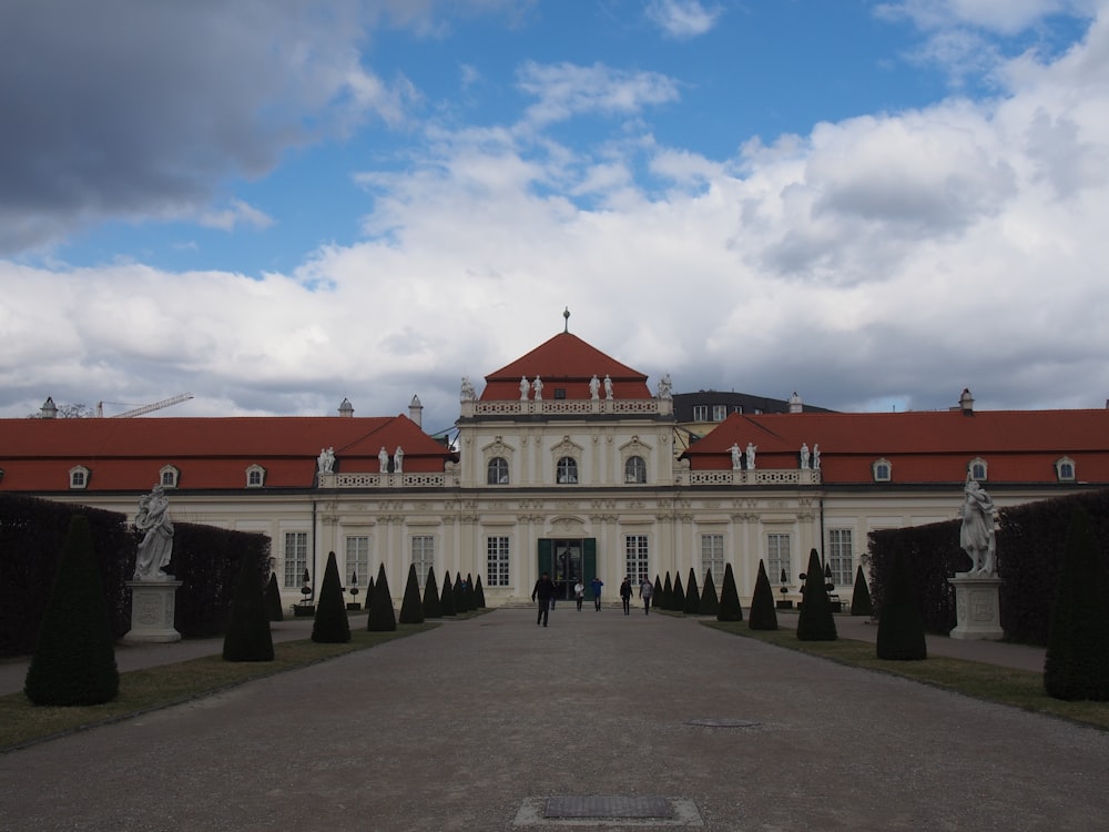 a large white building with statues in front of it