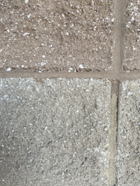 A construction worker inspecting a wall made of AAC blocks.