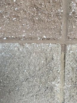 Close-up of textured decorative concrete wall blocks stacked neatly outdoors