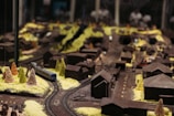 Brightly lit display of miniature play town setups showcasing detailed craftsmanship.
