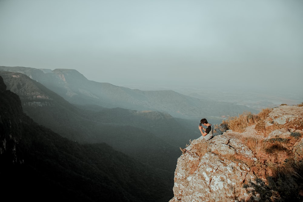 a man sitting on a rock