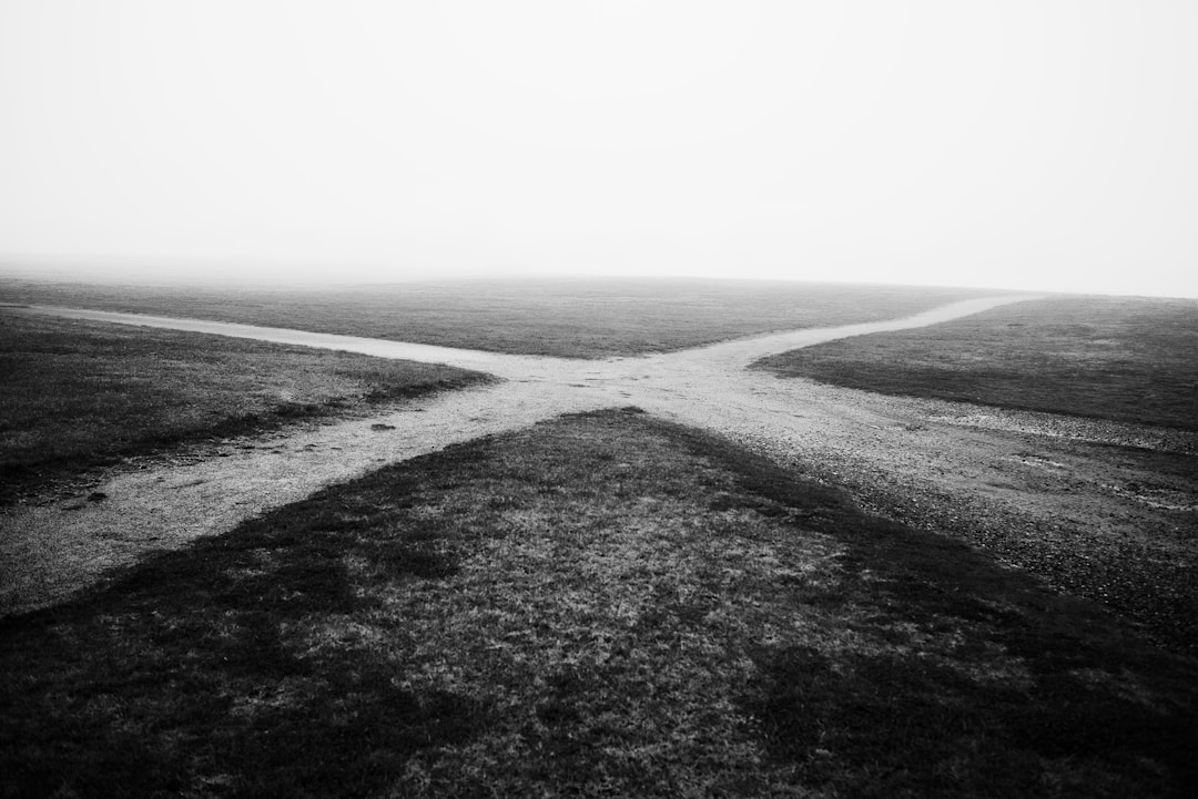 Intersecting gravel roads with fog representing a decision crossroads