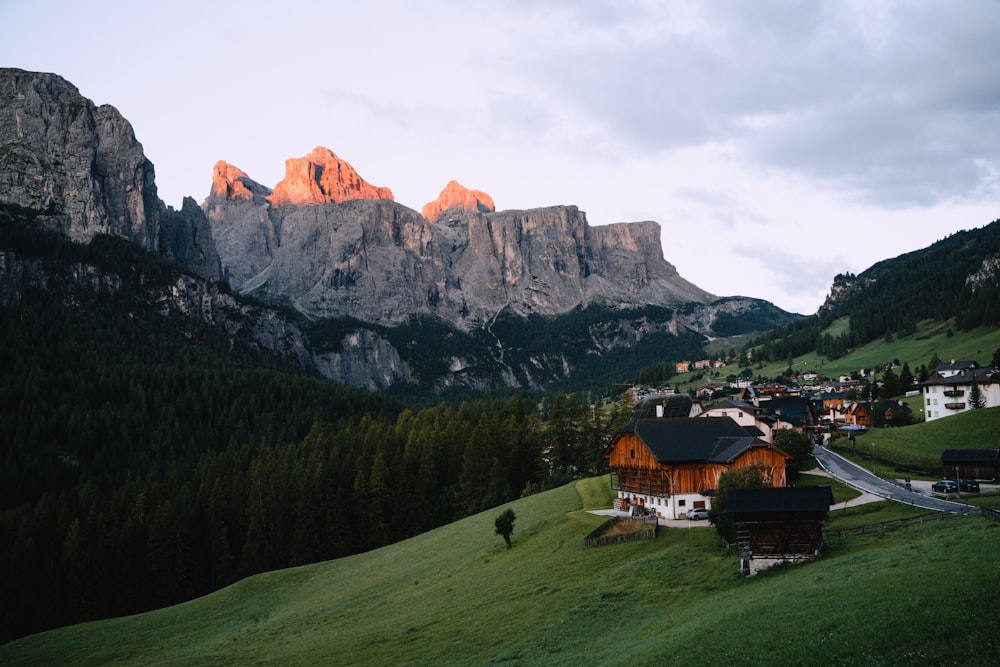 a small village in the mountains with Dolomites in the background