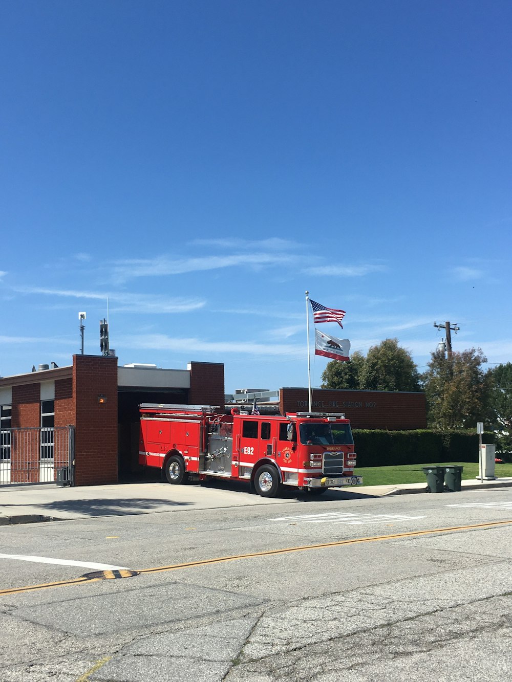 a fire truck parked in front of a building with flags