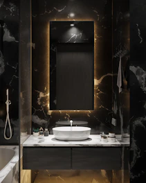 Bathroom with sleek fixtures, a large mirror, and soft ambient lighting.