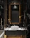 A stylish bathroom vanity with an elegant marble countertop and subtle lighting.