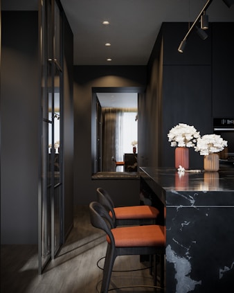 a kitchen with a bar and chairs