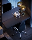 A stylish workspace with a desk and ergonomic chair.