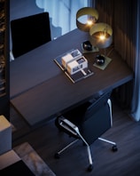 A sleek black ergonomic office chair with adjustable armrests in a modern workspace.