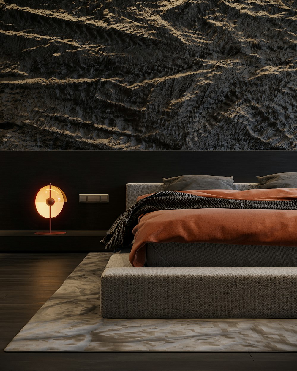 a bed and a lamp in a dark room with a mountain in the background