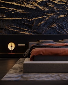 A stylish bedroom wall with textured wallpaper, reflecting a blend of comfort and design expertise.