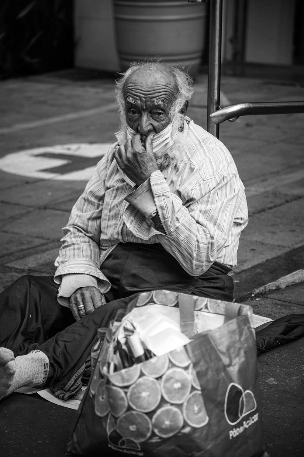 a man sitting on the ground with a bag of money