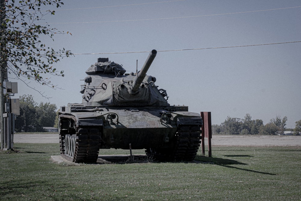 a military tank parked on grass