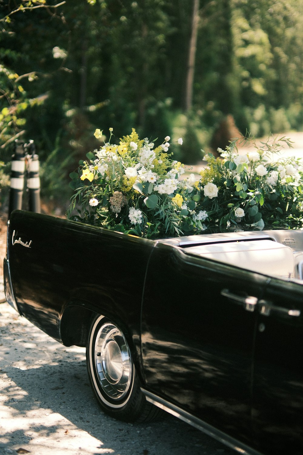 a black car with white flowers