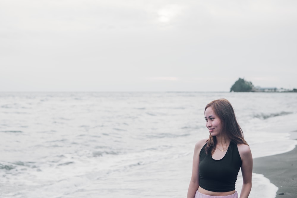 a woman standing on a beach