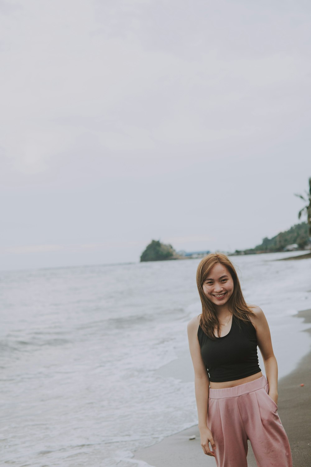 a woman standing on a beach