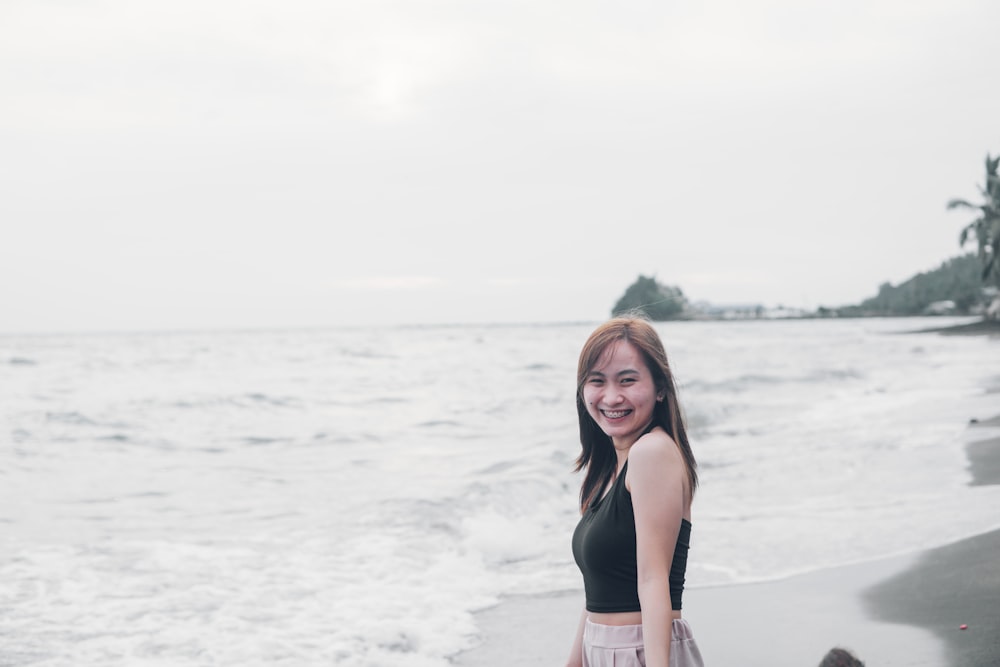 a woman standing on a beach