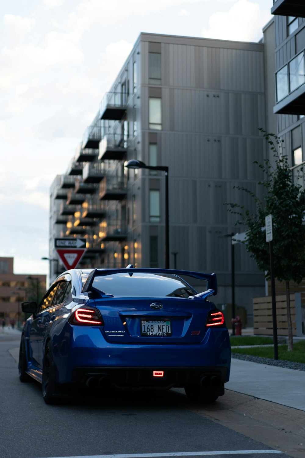 a blue car parked on the side of a road