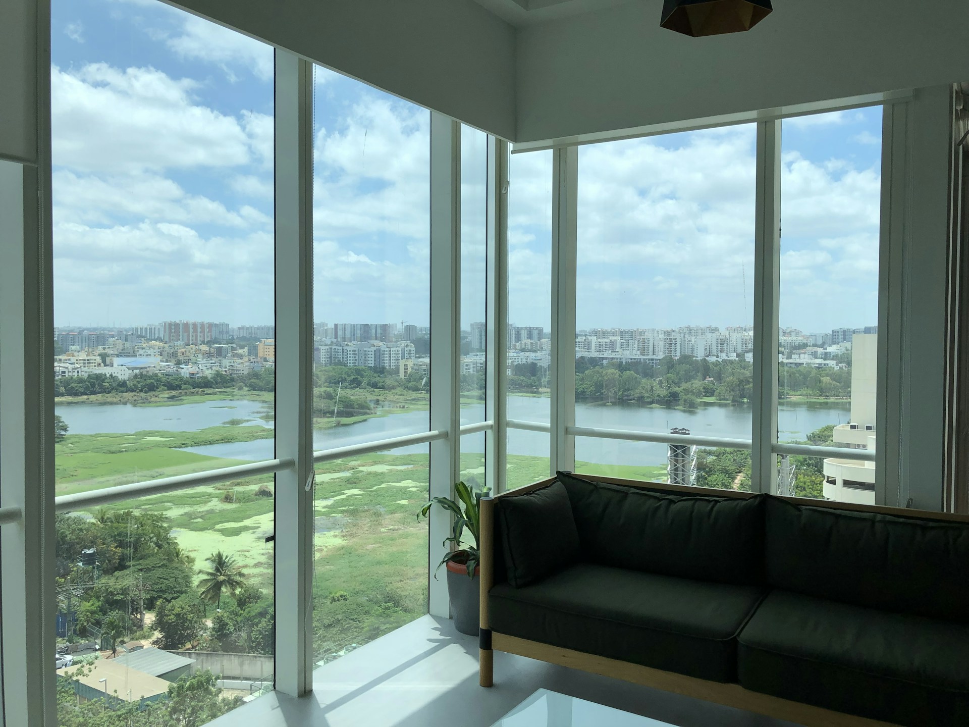 A luxurious interior shot of a spacious living room in one of Geonit Realty's premium apartments, with floor-to-ceiling windows and tasteful decor.