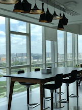 A sleek office meeting room with professionals collaborating against a backdrop of city skylines from London, New York, and Hong Kong.