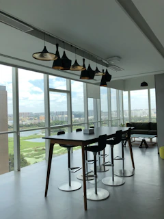 A sleek infinity table bathed in soft natural light inside a modern Phnom Penh penthouse.