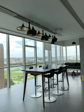 A sleek infinity table bathed in soft natural light inside a modern Phnom Penh penthouse.