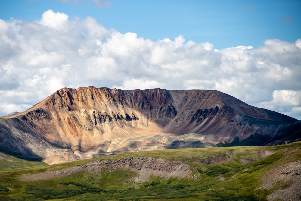 a mountain with clouds above it