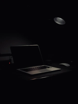 A calm workspace with a laptop and a privacy policy document on the screen.