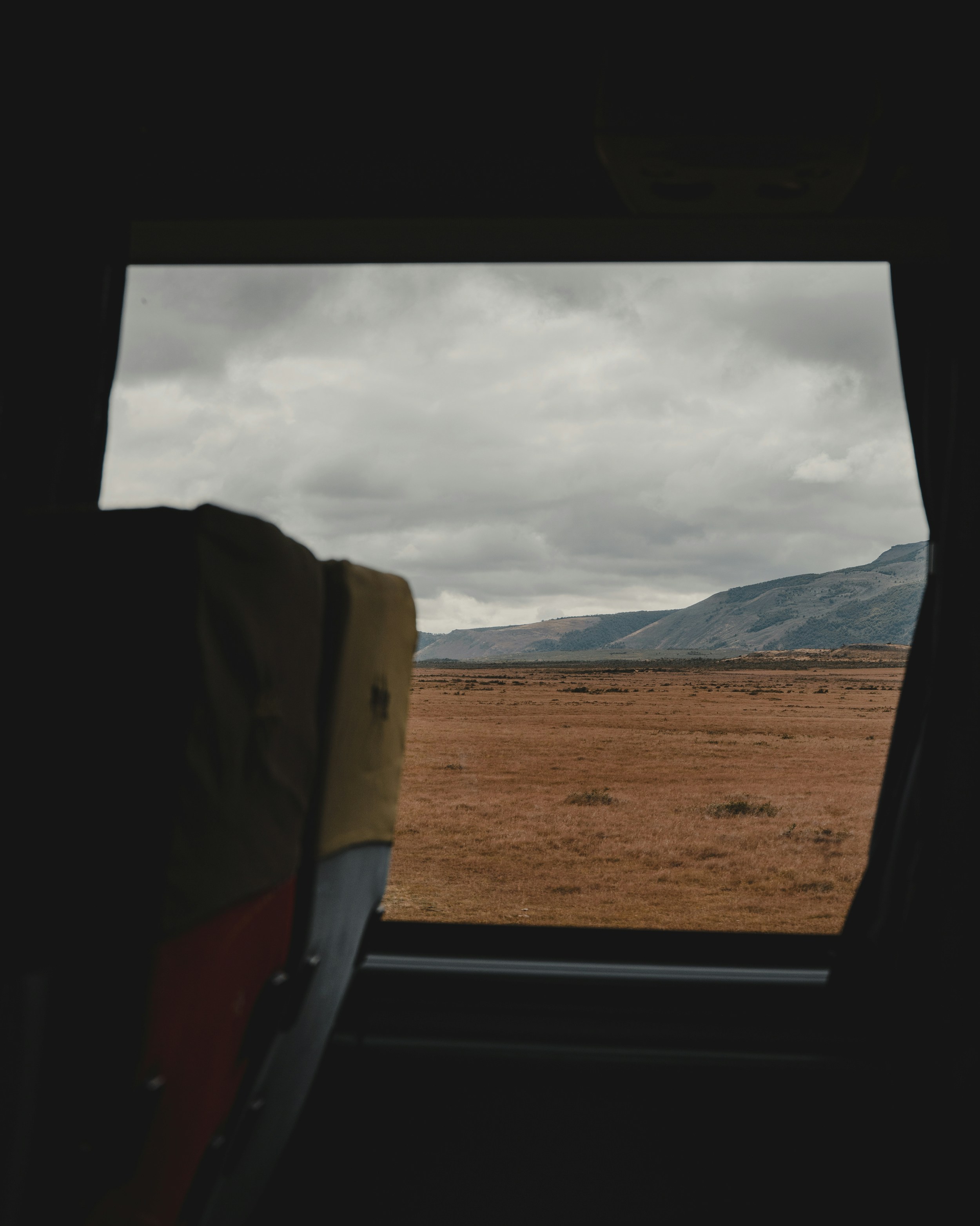 a view of a field from a plane window