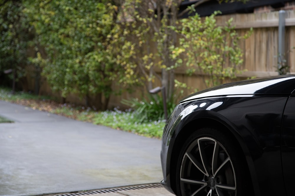 a black car parked on a road