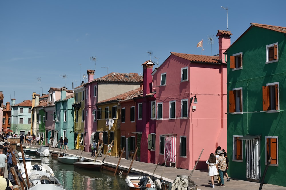 a group of colorful buildings next to a body of water