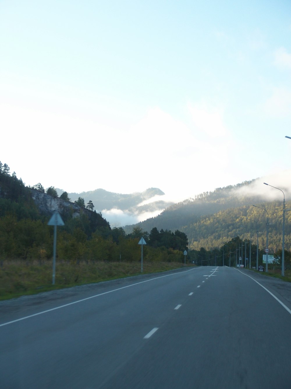 a road with mountains in the background