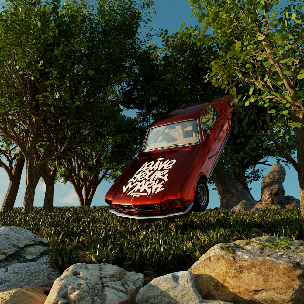 a red car parked on rocks