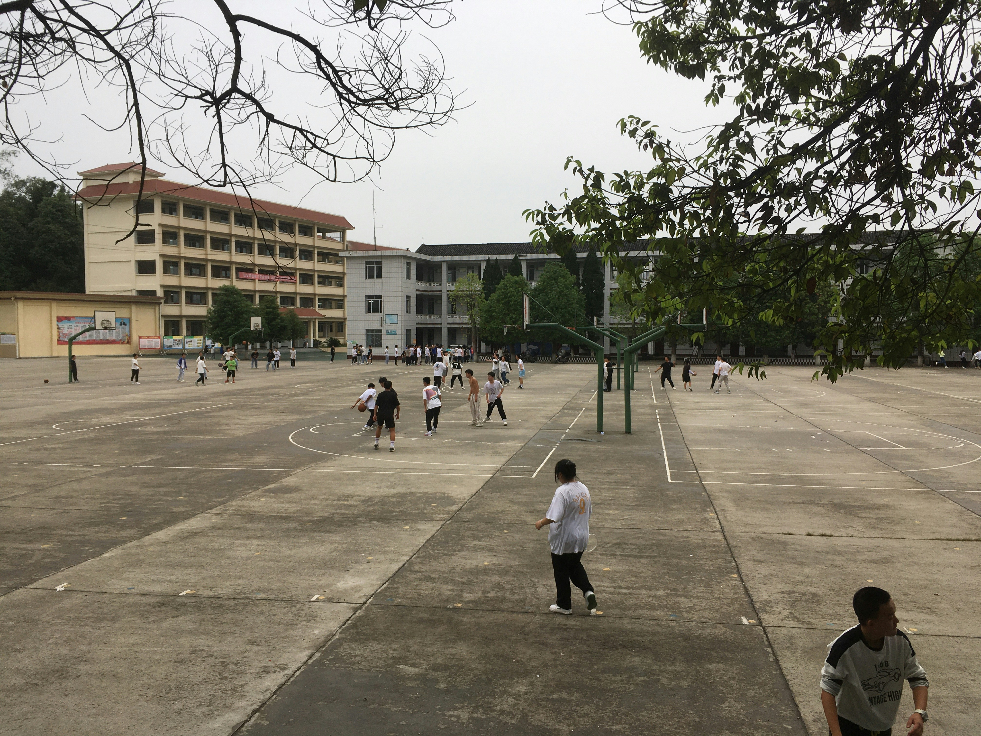 Students playing basketball on an outdoor court