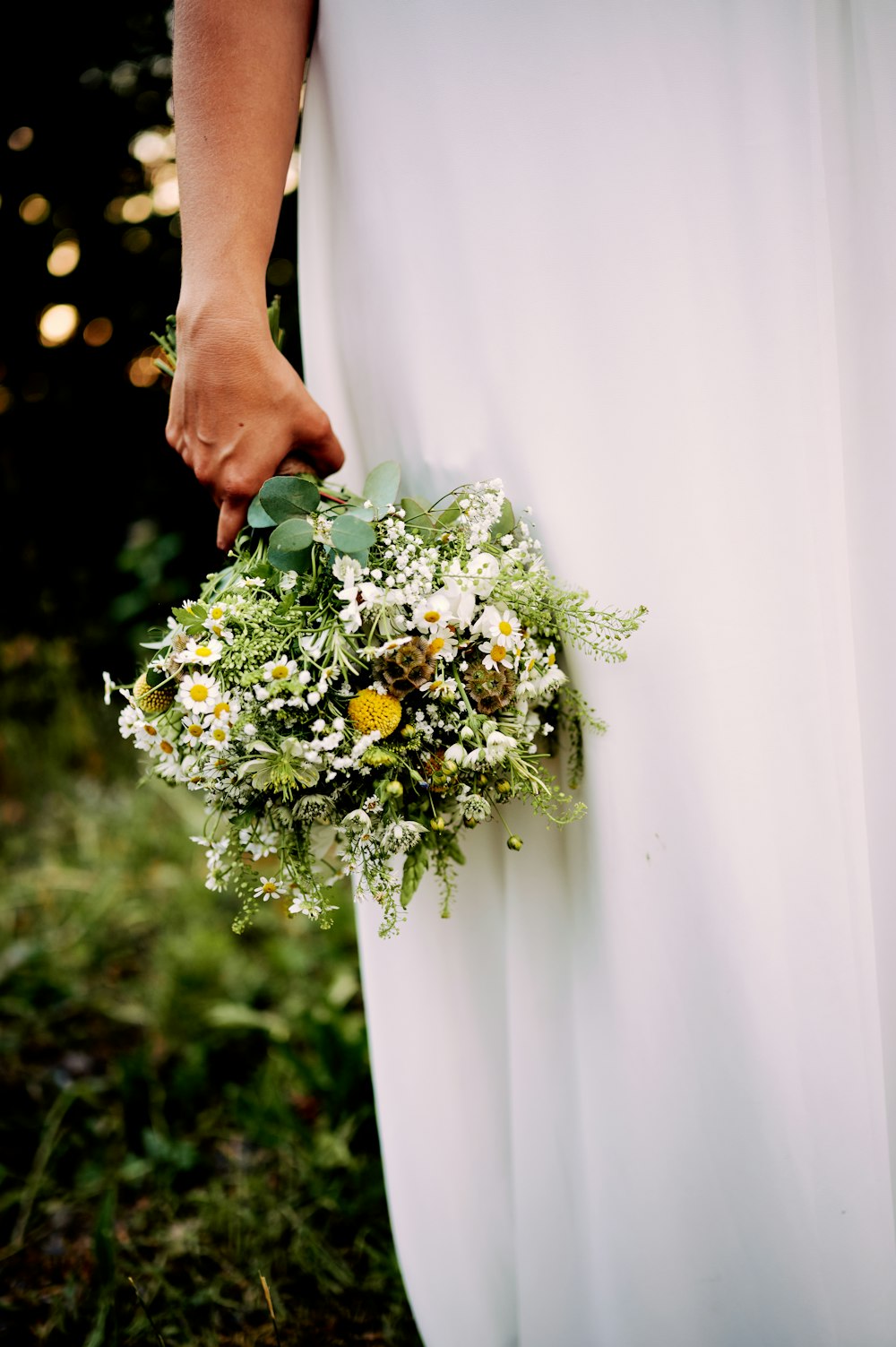 a person holding a bouquet of flowers