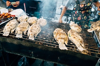 a person cooking food on a grill