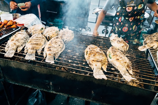 a person cooking food on a grill