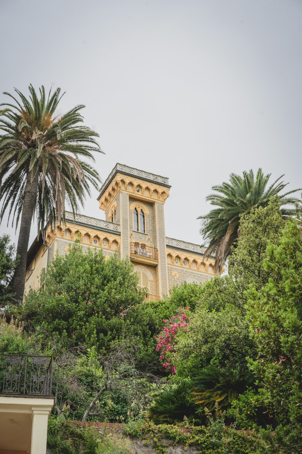 a building with a tower and trees around it