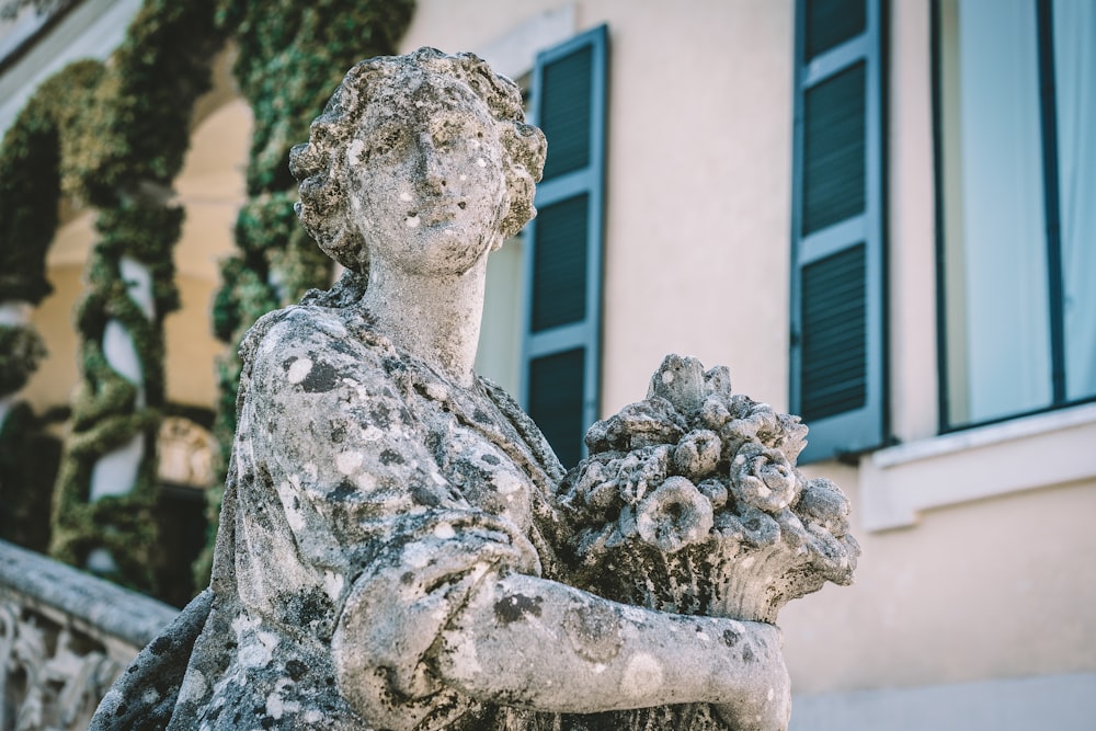 a statue of a person holding a flower