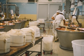 Workers in a clean, modern processing plant carefully canning tuna.