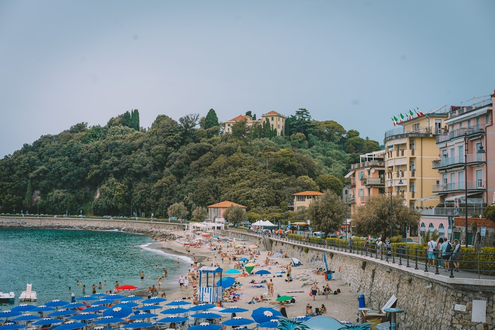 a beach with people and umbrellas